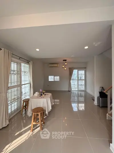 Spacious living room with modern decor and large windows for natural light.