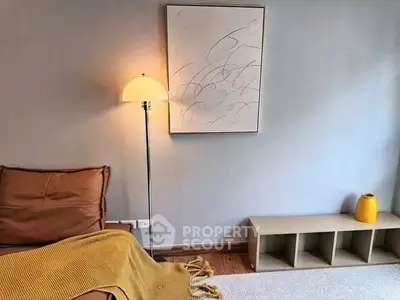 Cozy living room corner with modern decor and warm lighting.