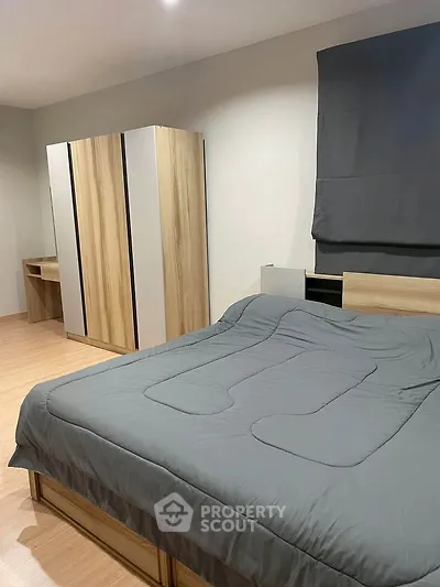 Modern bedroom with sleek wooden furniture and cozy bedding