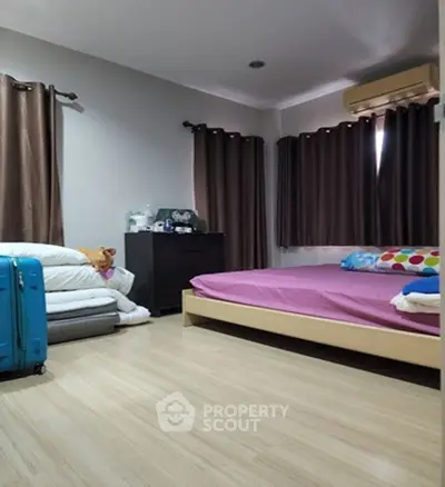 Cozy bedroom with modern decor and ample natural light, featuring a comfortable bed and stylish furnishings.