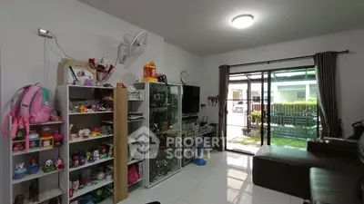 Charming living room with garden view, featuring modern decor and ample natural light.