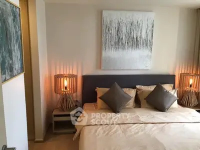 Elegant bedroom with modern decor and ambient lighting, featuring a cozy bed and stylish artwork.
