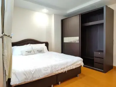 Spacious bedroom with modern wardrobe and cozy bed in a stylish apartment.