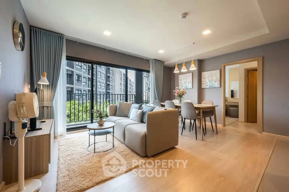 Modern living room with elegant decor and large windows in a stylish apartment.
