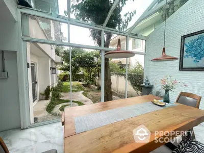 Spacious dining area with garden view and modern glass ceiling