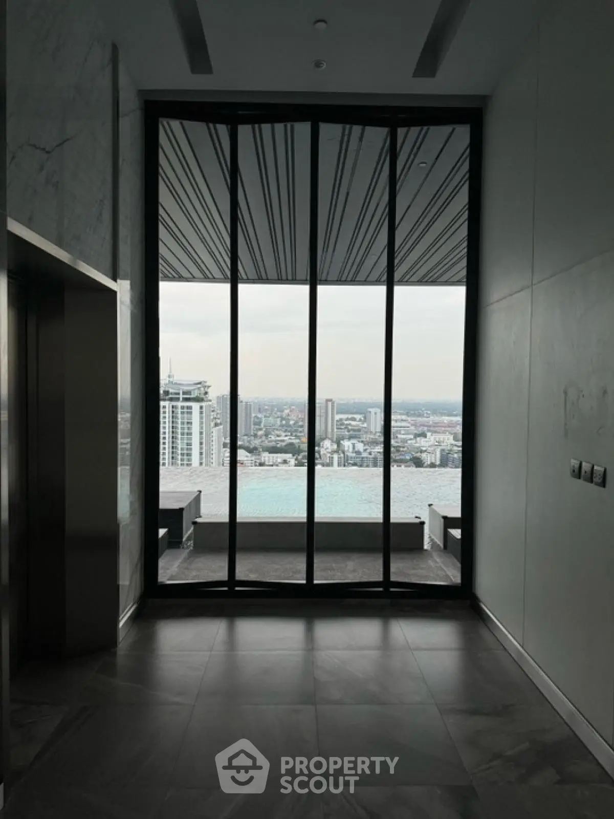 Luxurious high-rise building with stunning city view and infinity pool.