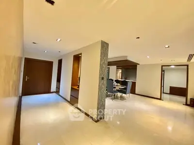 Spacious modern apartment interior with open layout and elegant dining area.
