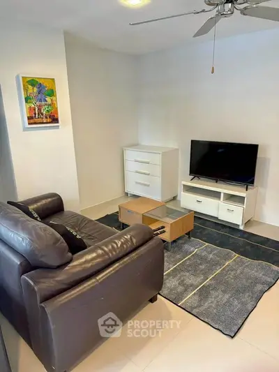 Cozy living room with modern furniture and wall art, perfect for relaxation.