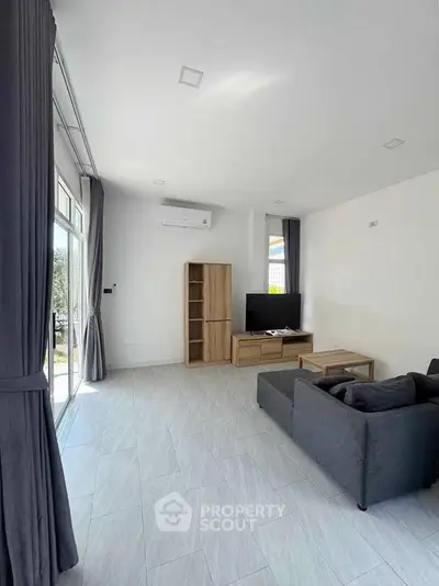 Spacious modern living room with sleek design and natural light