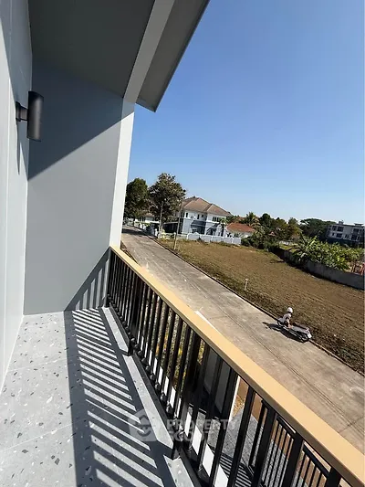 Spacious balcony with scenic view of suburban neighborhood and clear blue sky.