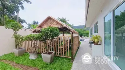 Charming garden with bamboo gazebo and modern house exterior, perfect for outdoor relaxation.