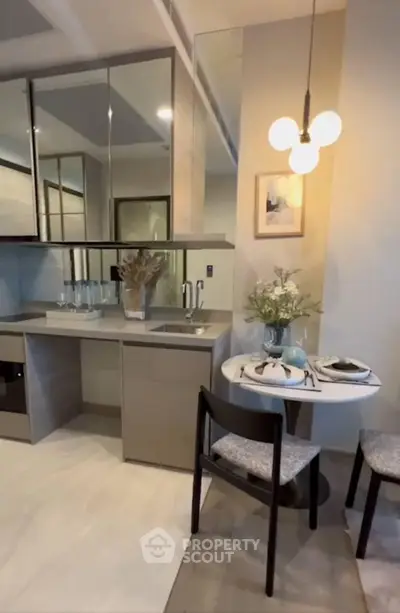 Modern kitchen with sleek cabinetry and cozy dining area