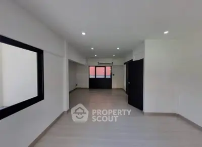 Spacious modern living room with sleek design and ample natural light.