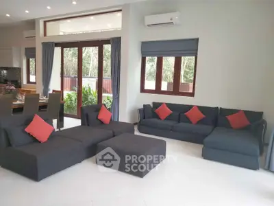 Spacious modern living room with stylish furniture and large windows for natural light.