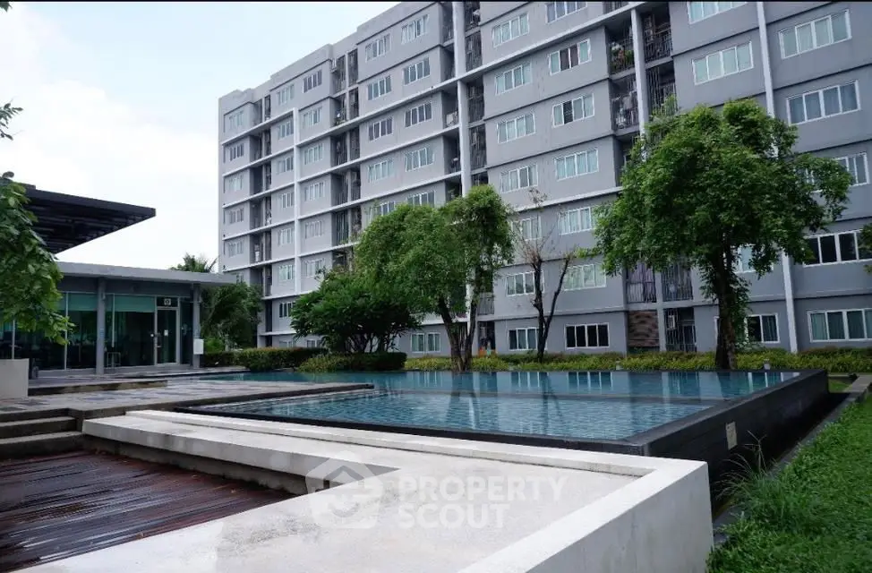 Modern apartment complex with pool and lush greenery, ideal for urban living.