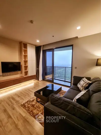 Modern living room with cozy sofa, stylish decor, and balcony offering stunning views.