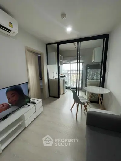 Modern apartment living room with open kitchen and balcony view