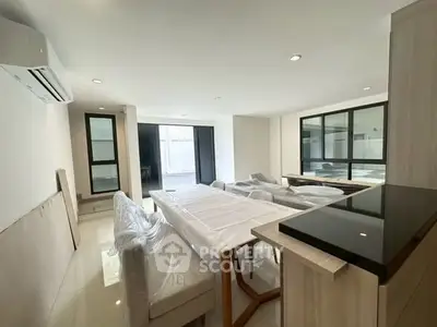 Spacious modern living room with sleek furniture and large windows for natural light.
