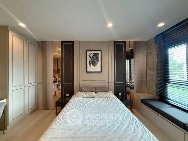 Luxurious bedroom with modern design and large windows offering natural light.