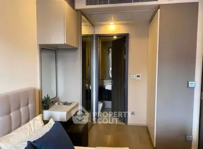 Modern bedroom with stylish decor and ensuite bathroom in luxury apartment.
