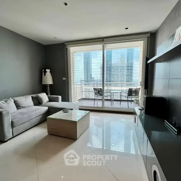 Modern living room with sleek design and city view balcony, perfect for urban living.