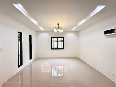 Spacious modern living room with sleek lighting and tiled flooring