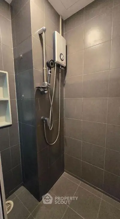 Modern bathroom with sleek shower and dark tile design