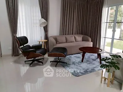 Stylish living room with modern furniture and large windows for natural light.