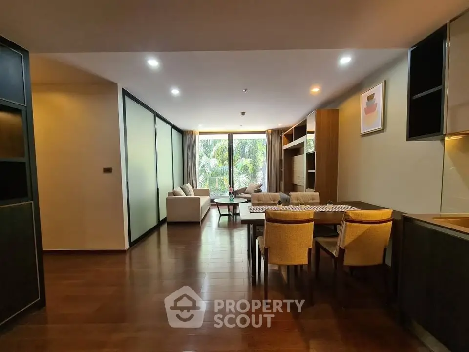 Spacious modern living room with elegant dining area and large windows