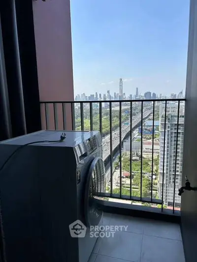 High-rise balcony with washing machine and stunning city view