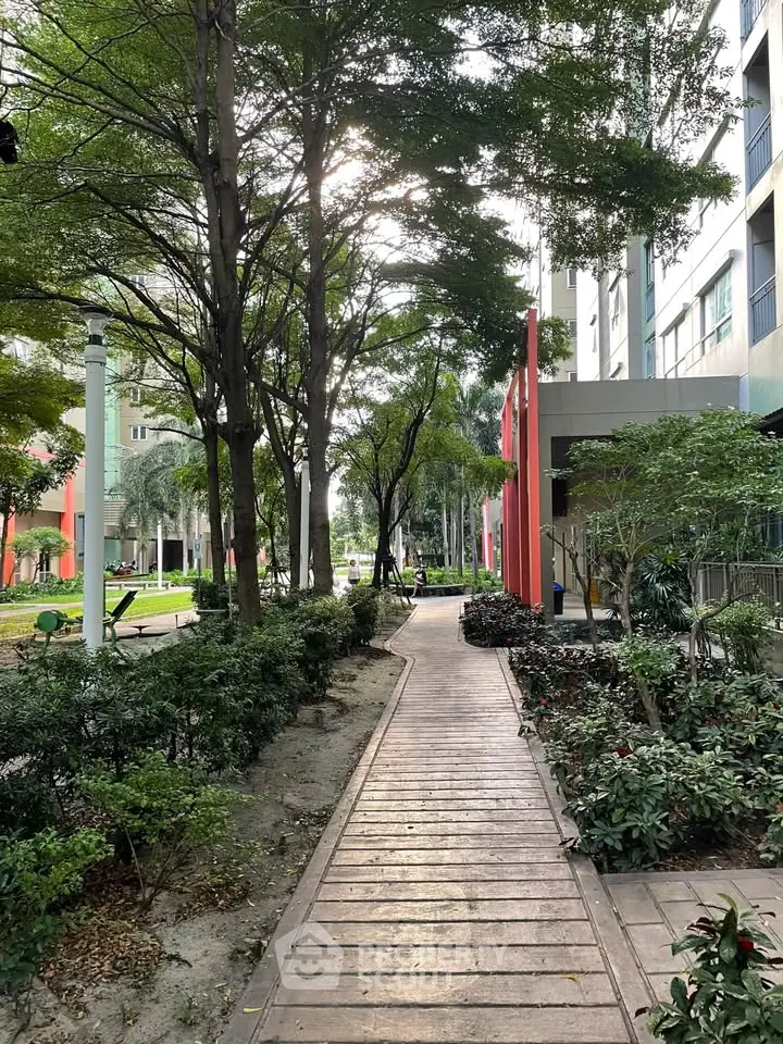 Charming garden pathway with lush greenery and modern building facade