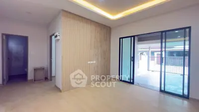 Spacious modern living room with sliding glass doors and wooden accent wall