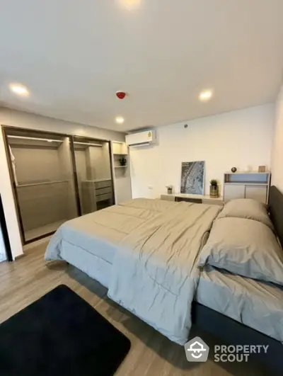 Modern bedroom with sleek design and spacious walk-in closet