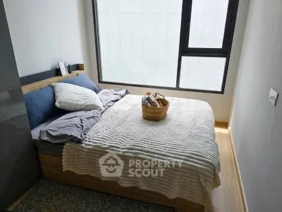Cozy modern bedroom with large window and stylish decor