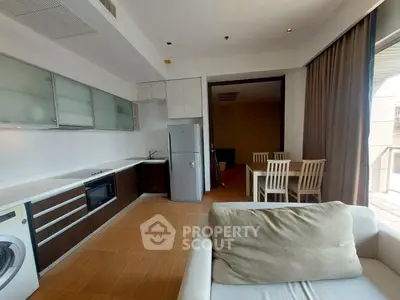 Spacious open-layout kitchen and dining area with modern appliances and natural light.