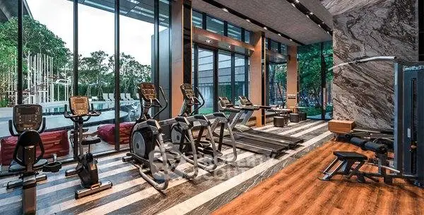 Luxurious gym with modern equipment and floor-to-ceiling windows offering a stunning view.