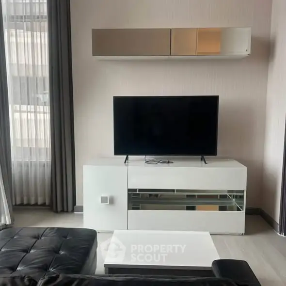 Modern living room with sleek TV setup and stylish furniture