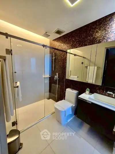 Modern bathroom with glass shower and sleek fixtures