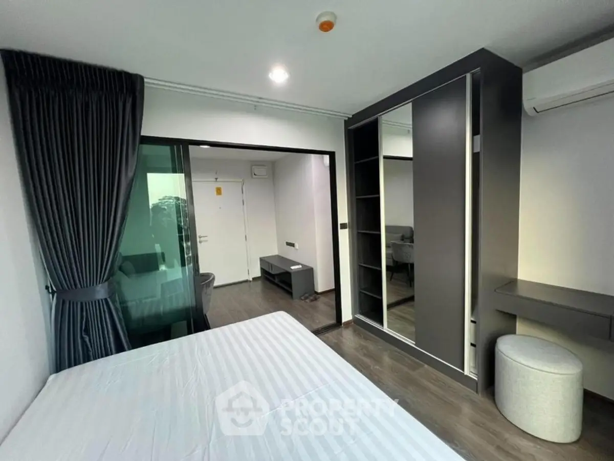 Modern bedroom with sleek design and built-in wardrobe in a stylish apartment.