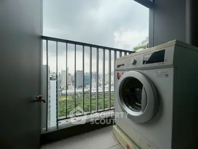 Modern balcony with washing machine and city view, perfect for urban living.