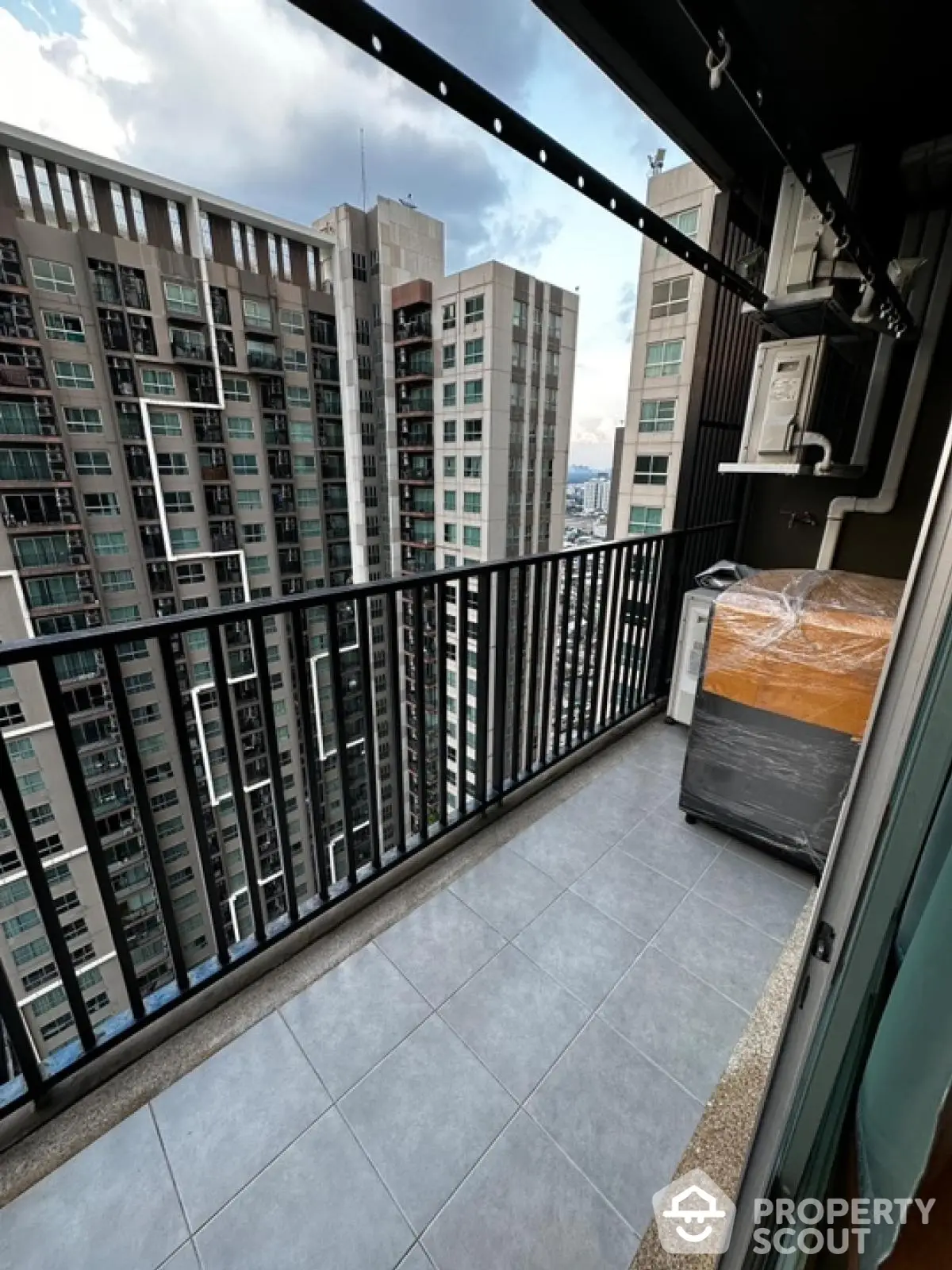 Spacious balcony with city view in modern high-rise apartment