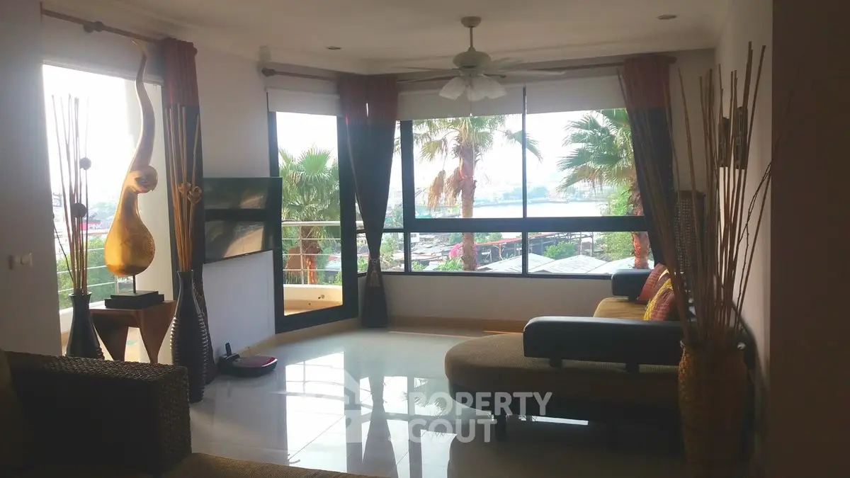 Spacious living room with large windows offering stunning views and modern decor.