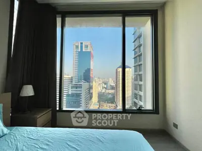 Stunning city view from modern bedroom window in high-rise apartment