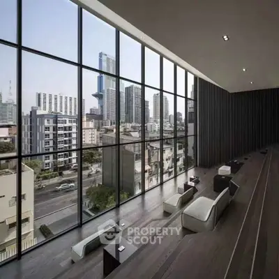 Luxurious modern living room with floor-to-ceiling windows offering stunning cityscape views.