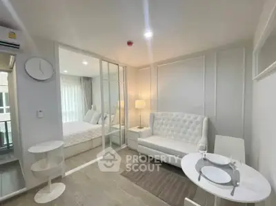 Modern studio apartment with elegant white decor and cozy living area