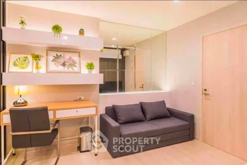 Modern living room with stylish decor and workspace, featuring a cozy sofa and elegant desk.
