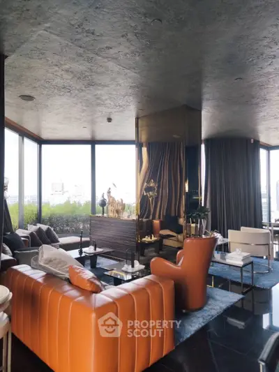 Luxurious modern living room with panoramic city views and stylish orange leather sofas.