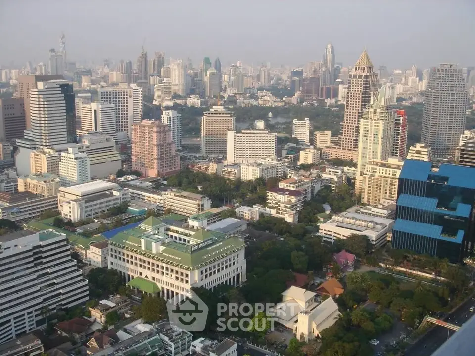 Stunning aerial view of a bustling cityscape with modern skyscrapers and lush greenery.