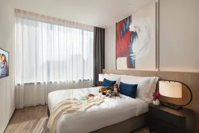 Modern bedroom with large window, stylish decor, and cozy ambiance