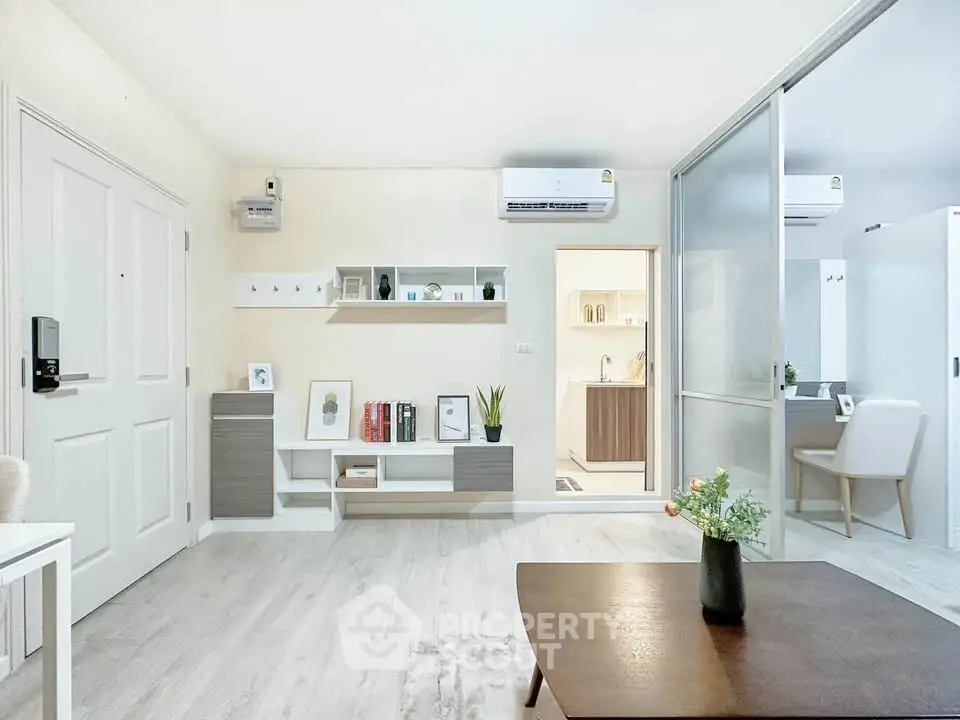 Modern living room with sleek furniture and open layout, featuring air conditioning and stylish decor.